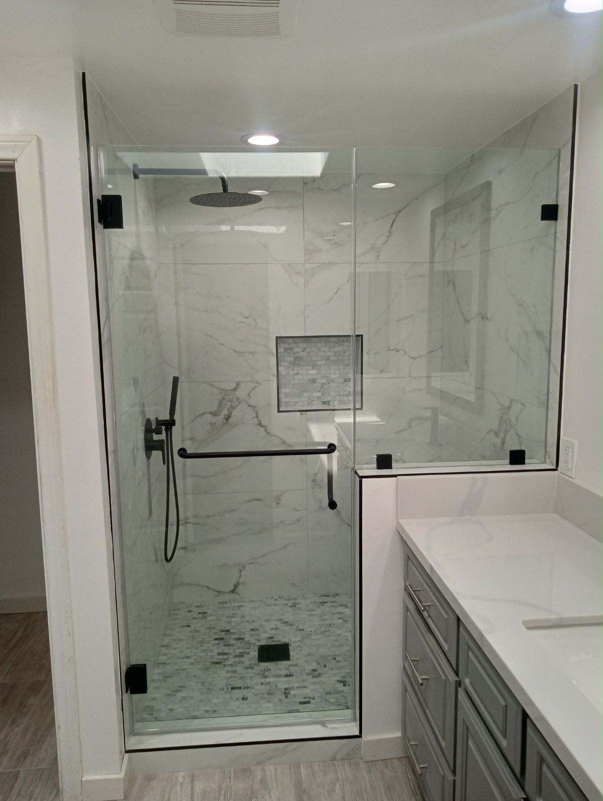 Finished Anaheim bathroom with a glass shower and marble-look tile